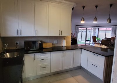 Built-in kitchen cabinets with white and wood accents