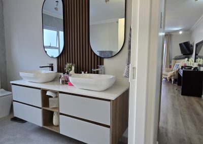 Floating bathroom vanity with woodgrain finish and stone top