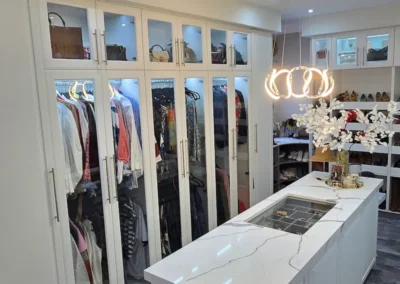 A crisp clean, white and glass detail walk in closet for the those with the finest of tastes