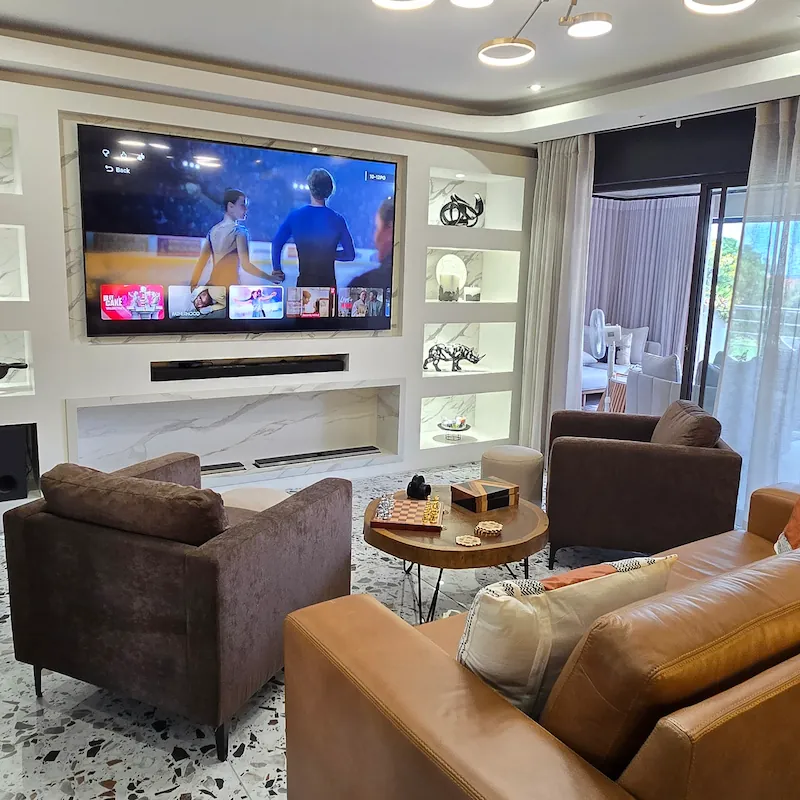 This luxurious and bold built in TV unit as a centre piece to the room with brilliant white LED lighting and built in fire place