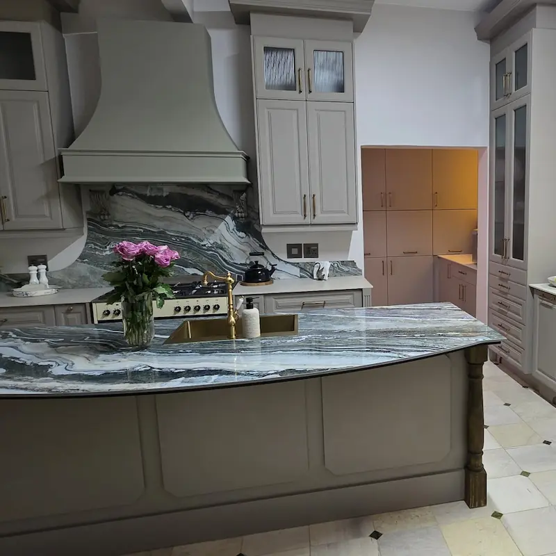 A classic and contemporary kitchen with custom joinery and cabinetry elements finished with muted white and centre piece counter tops
