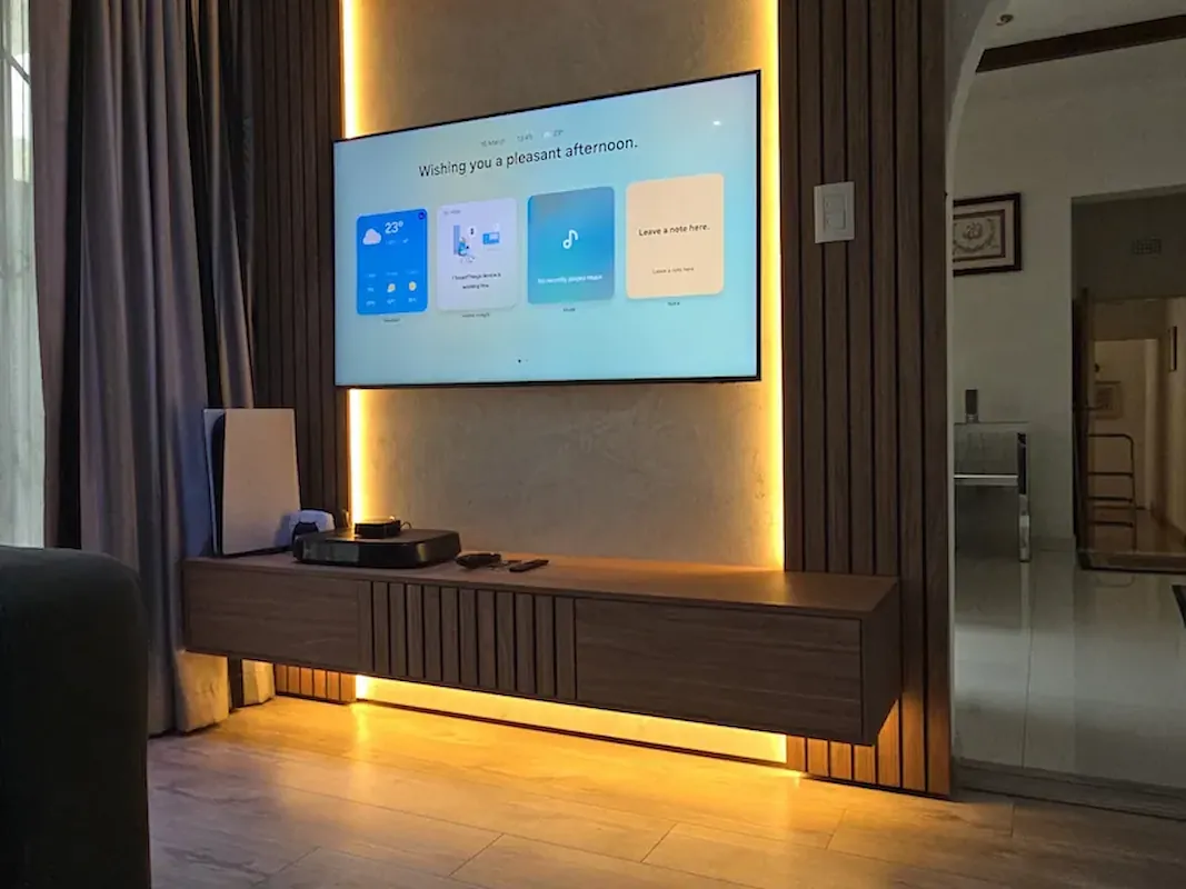 An elegant floating TV unit with soft LED lighting and timber details