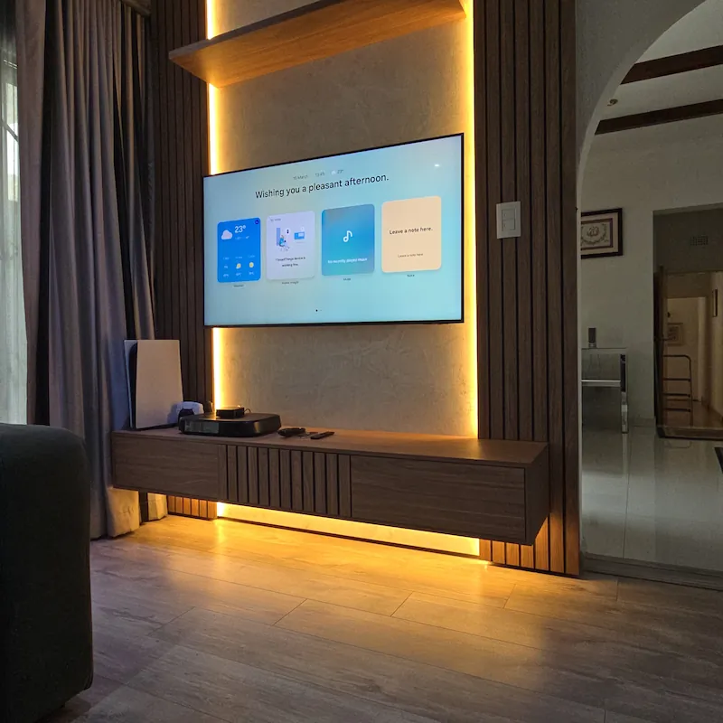 An ultra modern floating TV unit with warm white LED lighting finished with a stucco backing detail that effortlessly compliments the area