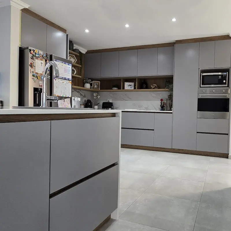 Sleek and modern kitchen with warm timber accents on muted grey fascias