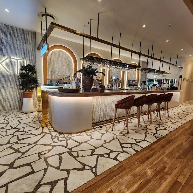 Custom hospitality joinery with bar counter, shelving, warm lighting, and refined commercial finishes