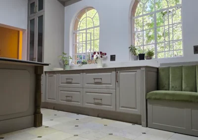 Custom kitchen cabinetry in Linksfield with arched windows, built-in storage and upholstered bench seating