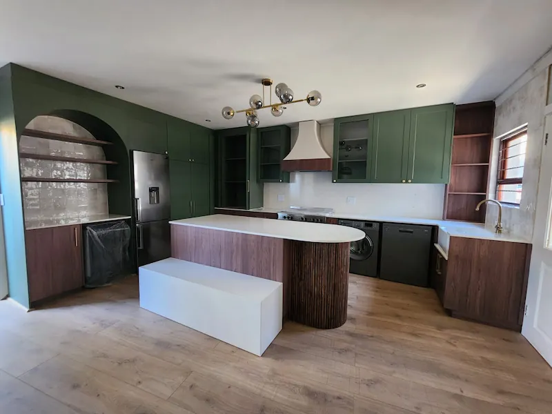 Custom Kitchen Cupboards Johannesburg Green and Timber Design Custom kitchen cupboards in Johannesburg with green cabinetry, timber finishes, curved island detail and integrated storage by Oakmont Kitchens & Interiors