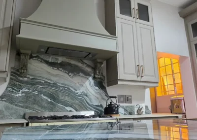 Statement stone splashback and island surface in a luxury Linksfield kitchen by Oakmont Kitchens & Interiors