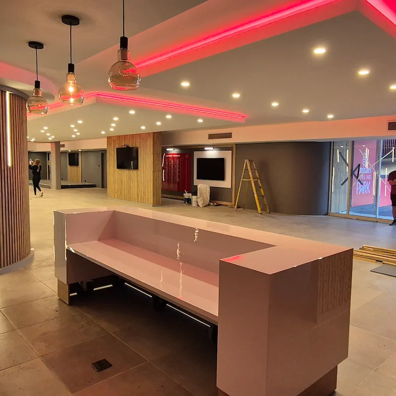 Office reception joinery with custom counter, wall panelling, storage cabinetry, and refined commercial detail