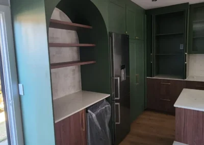 Luxury kitchen in Bedfordview with green custom cabinetry, arched coffee station and timber shelving by Oakmont Kitchens & Interiors