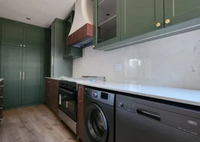 Modern luxury kitchen in Bedfordview with custom cabinetry, brass handles, built-in appliances and refined material contrast